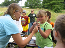 Scientist Pat Heglund demonstrates bird release at Environmental Explorers Camp