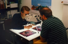 USGS Scientists Kevin Hop and Larry Robinson examine aerial photographs with a stereo scope