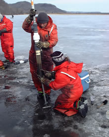 USGS scientist Pete Boma and Jennifer Cavanaugh retrieve ice core to obtain sediment samples for the nitrogen project