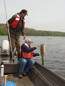 USGS scientist Tom Custer and US Fish and Wildlife Service biologist Dave Warburton check swallow boxes